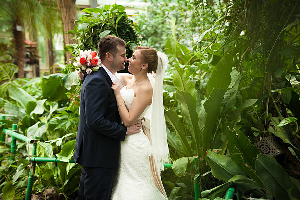 istock Newly married couple kissing at forest 515786599