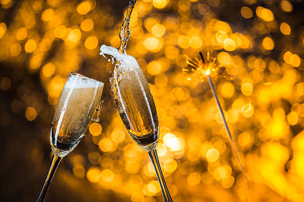 istock New Year's at midnight with champagne glasses on light background 515787720