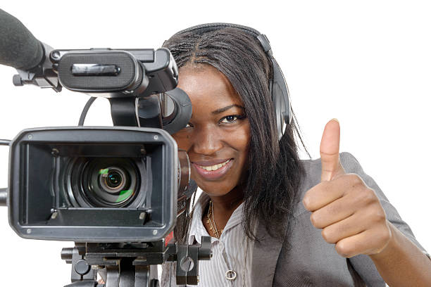 istock young African American woman with professional video camera 515788026