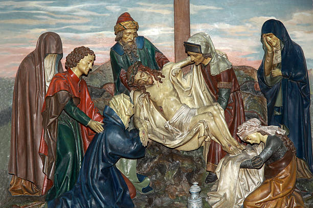 istock Jesus is taken down from the cross 515789058