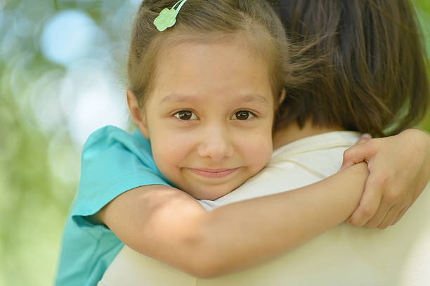 istock girl with mother in park 515790202