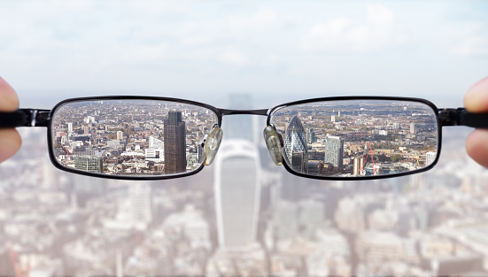 Clear business vision concept businessman looking at the financial district of the city of London