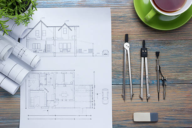 istock Architect worplace top view. Architectural project, blueprints, blueprint rolls and 515792656