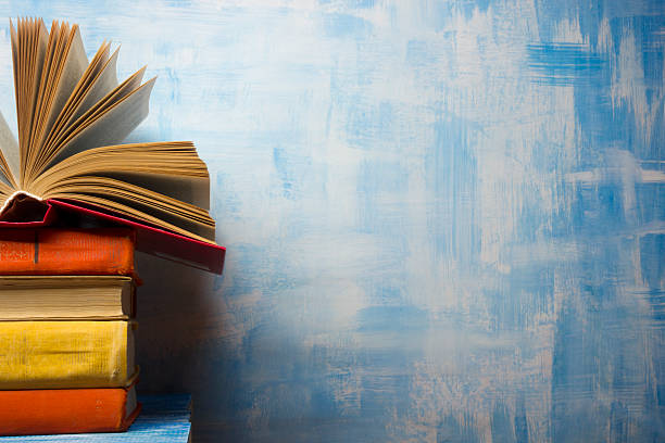 Open book, hardback books on wooden table. Back to school