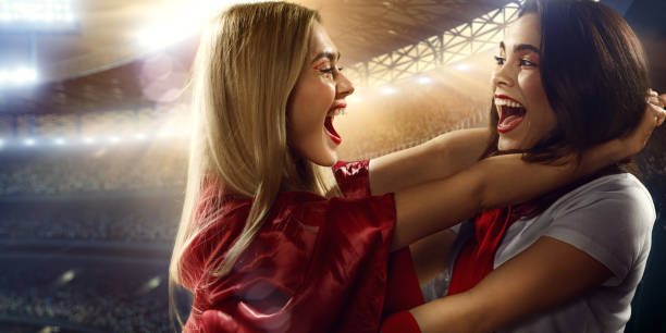Sport fans: Girls shouting and hugs each other