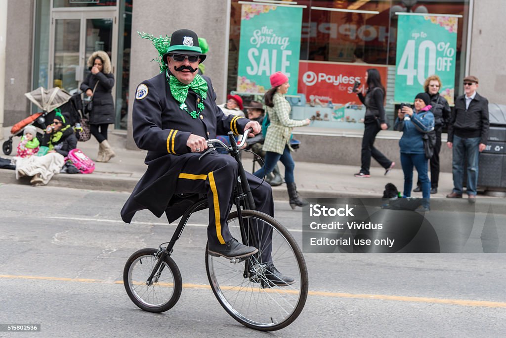 St. Patrick's Day Parade in Toronto Toronto, ON, Canada - March 13, 2016:  St. Patrick's Day Parade in the downtown of Toronto. This Irish national holiday is an old Irish tradition and takes place annually in Toronto. Older man in fun cop costume enjoying the Irish parade spirit. St. Patrick's Day Stock Photo