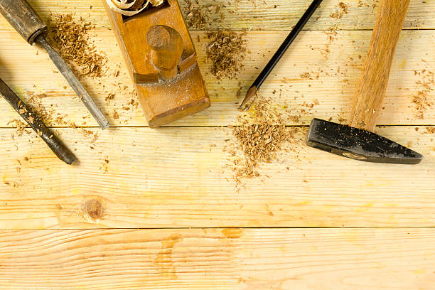 istock Carpenter tools on wooden table with sawdust. Craftperson workplace top 515802632