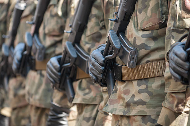 istock Army parade - armed soldiers in camouflage military uniform 515803094