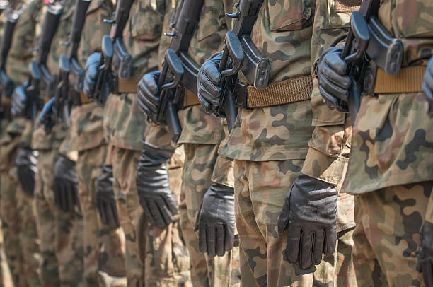 istock Army parade - armed soldiers in camouflage military uniform 515803228