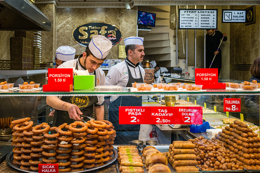 Istanbul, Turkey - March 10, 2015: Men is selling sweets and other food in the Market in Istanbul, Turkey