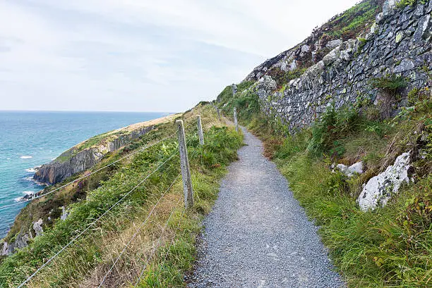 Stone rocks mountain hiking path at Irish seacoast. Bray, Greystone