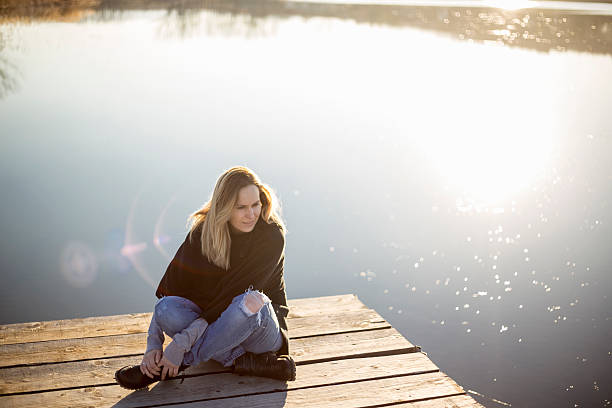istock Young woman relaxes on lake 515805718