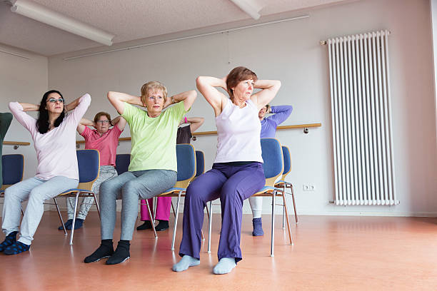 istock teacher and active senior women yoga class on chairs 515806418