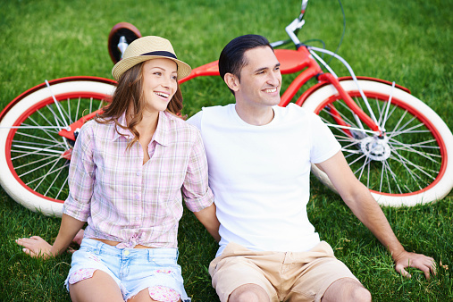 A cropped shot of a happy young couple relaxing on the grass in front of a retro bicyclehttp://www.azarubaika.com/iStockphoto/2014_06_22_City_Bike.jpg