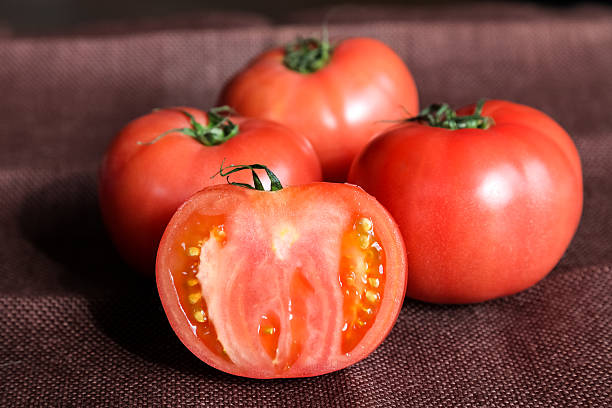 istock fresh tomatoes with green leaves 515806924