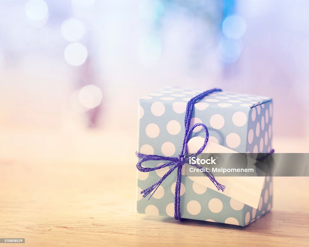 Blue and White Gift box Polka dot present box with label in a bright room Birthday Present Stock Photo