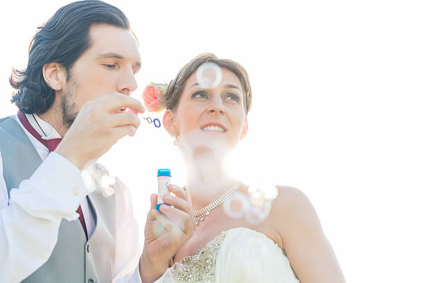 istock Wedding couple blowing soap bubbles outside 515809900