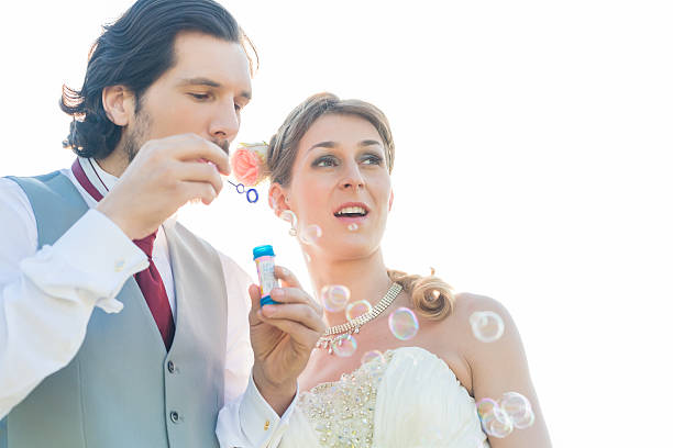 istock Wedding couple blowing soap bubbles outside 515810048