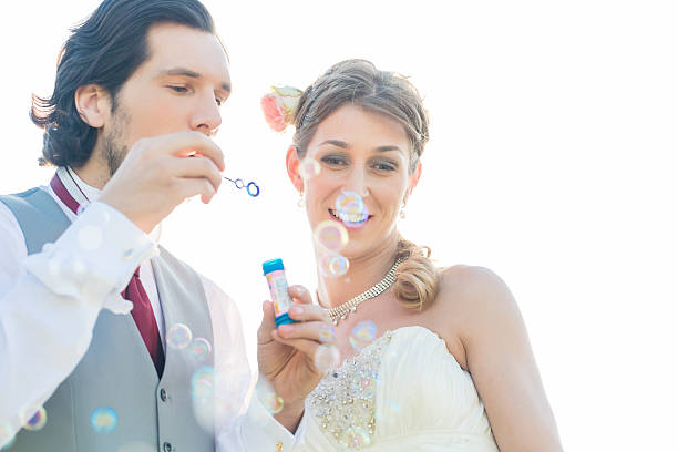istock Wedding couple blowing soap bubbles outside 515810140