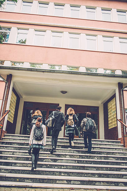 Five Turkish Students Going to School, Istanbul Turkish students walking to school. They are ascending the staircase, outdoors, campus. Cold autumnal morning. Nikon D800, full frame, XXXL. high school building stock pictures, royalty-free photos & images