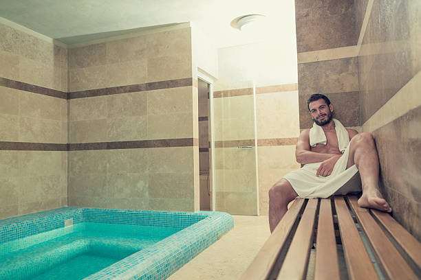 istock Black bear undressed man sit on bench relaxing in spa 515810779