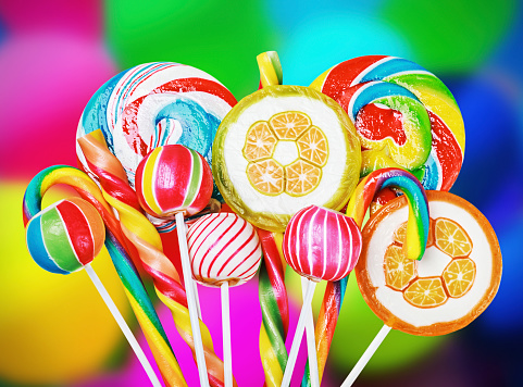 Colorful candies and sweets in the background of balloons