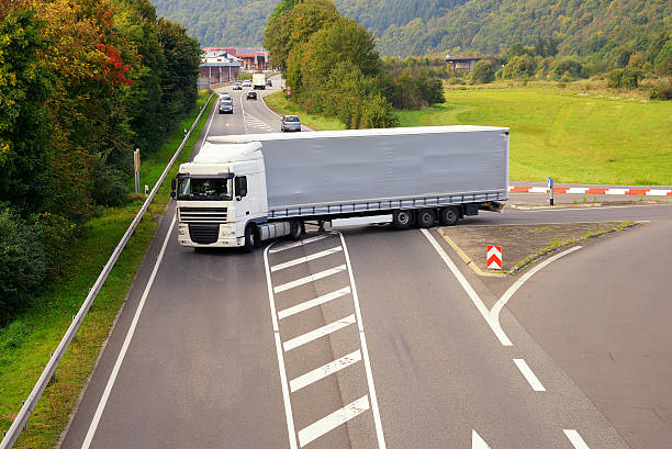 istock Large commercial truck makes left turn at intersection 515811397