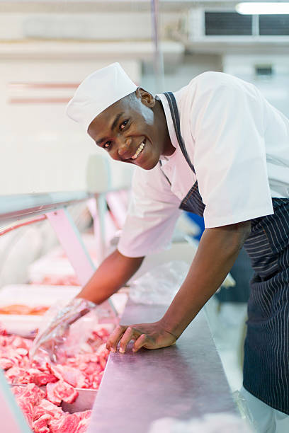 istock african american butcher picking raw meat 515812066