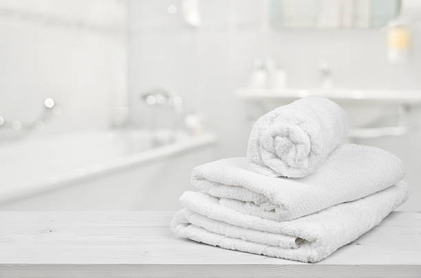 istock Stack of folded white spa towels over blurred bathroom background 515812174