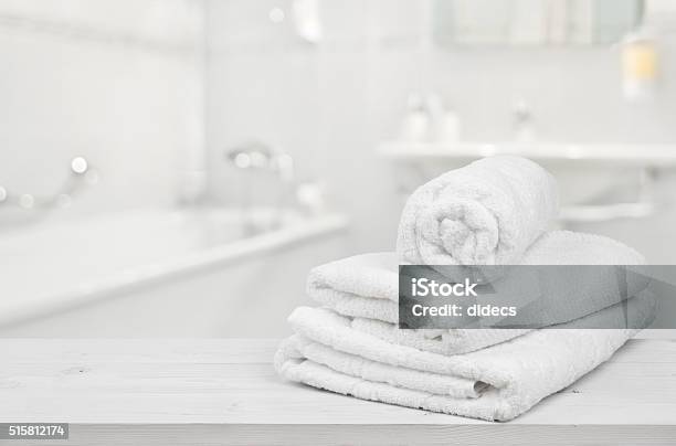 Stack Of Folded White Spa Towels Over Blurred Bathroom Background Stock Photo - Download Image Now