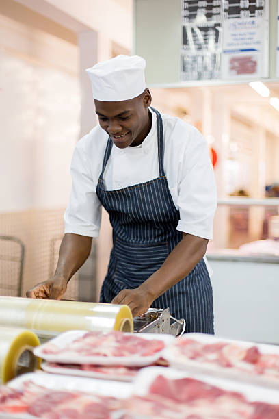 istock african american butcher wrapping meat 515813684