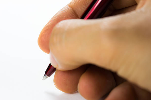 istock pen in the hand over white background 515813752