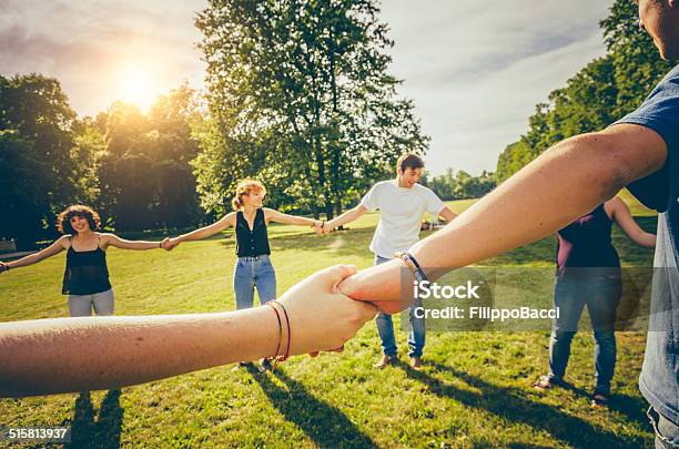 Friends Holding Hands In The Park Stock Photo - Download Image Now - 14-15 Years, 16-17 Years, 18-19 Years