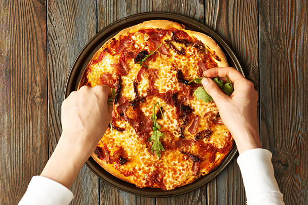 istock Home made pizza on wooden table 515814440