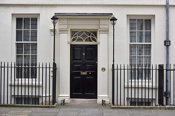 Eleven Downing Street London, UK - March 16th 2016:The  front door of 11 Downing Street (commonly known as Number 11),  the official residence of  the Chancellor of the Exchequer - Britain's Finance Minister. chancellor photos stock pictures, royalty-free photos & images