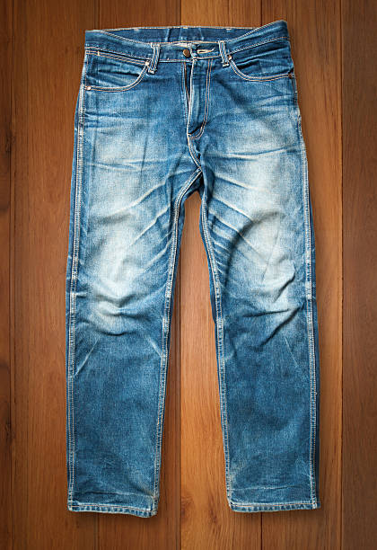 istock Blue jeans trouser on wood background 515815070
