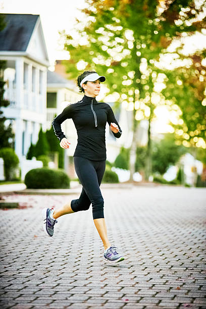 istock Woman Walking Dog 515817114