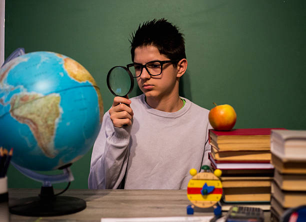 istock Boy looking through magnifying glass. School, education concept. 515823848