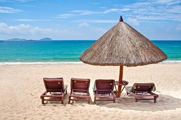 istock Loungers and straw umbrella on a tropical beach 515824222