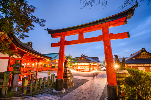 Kyoto, Japan- November 23, 2015: Motion blur of visitors at Fushimi Inari Taisha Shrine. The shrine is noted for its numerous torii gates.