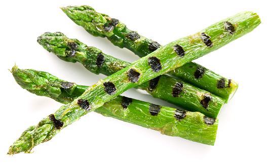 Grilled shoots of asparagus isolated on a white background.