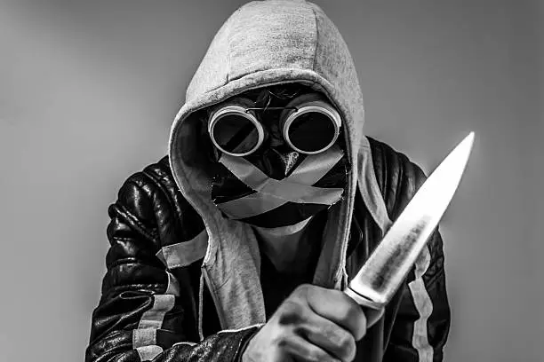 End times with knife, leather jacket and hood.