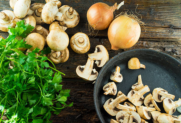 istock Mushrooms with parsley on the table, with a  frying pan. 515830856