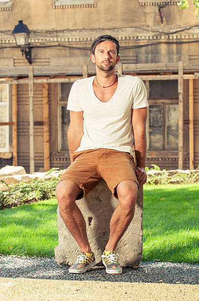 istock Attractive young man sitting outside and wearing casual clothes 515832882