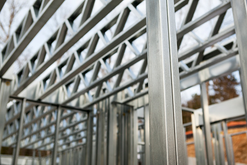 New steel house construction framework. Recycled metal is a popular building material in Europe and is seeing increased use in North America. Components are fabricated offsite and assembled quickly onsite with screws, eliminating cutting.