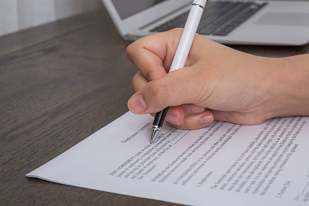 istock Close up of hand completing an employment application form 515838843