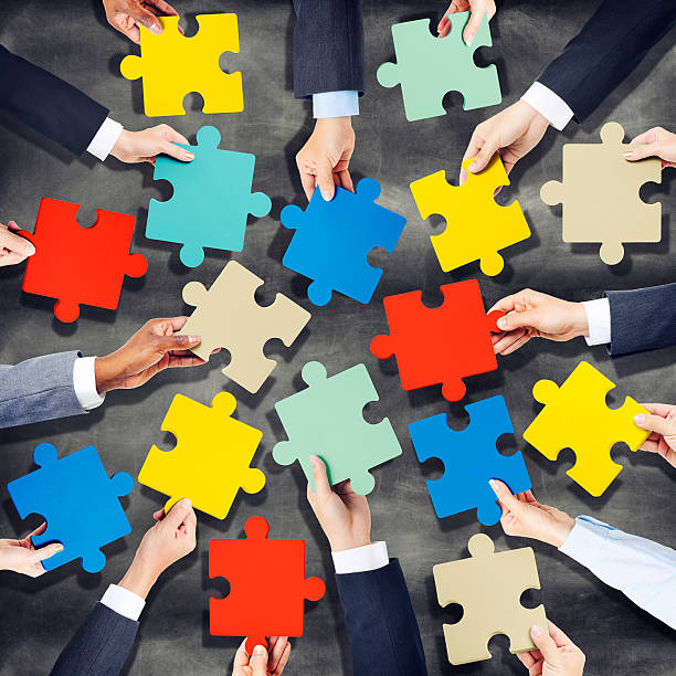 istock Group of Hands Holding Colourful Jigsaw Pieces 515842027