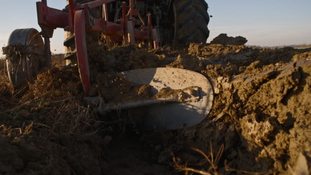 SLO MO Plowing the land