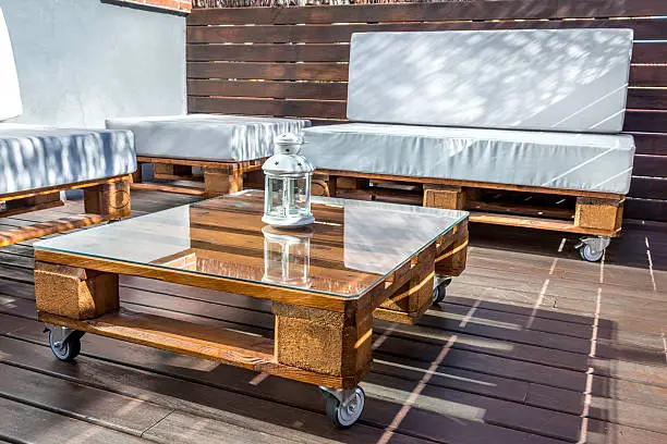 Modern recicling forniture in a terrace set on a wooden deck.