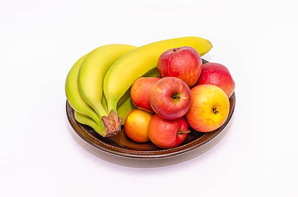 istock Bananas and apples on the dish on white background 515853666